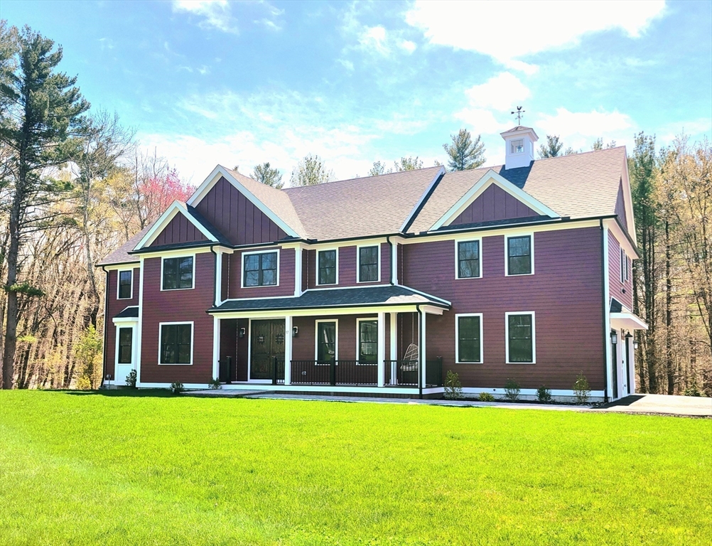 a aerial view of a brick house with a yard