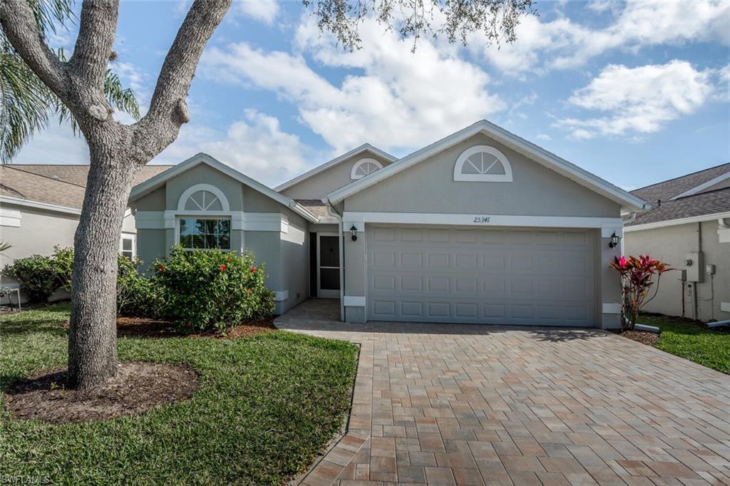 Ranch-style home with a newly brick paved driveway and 2 car garage