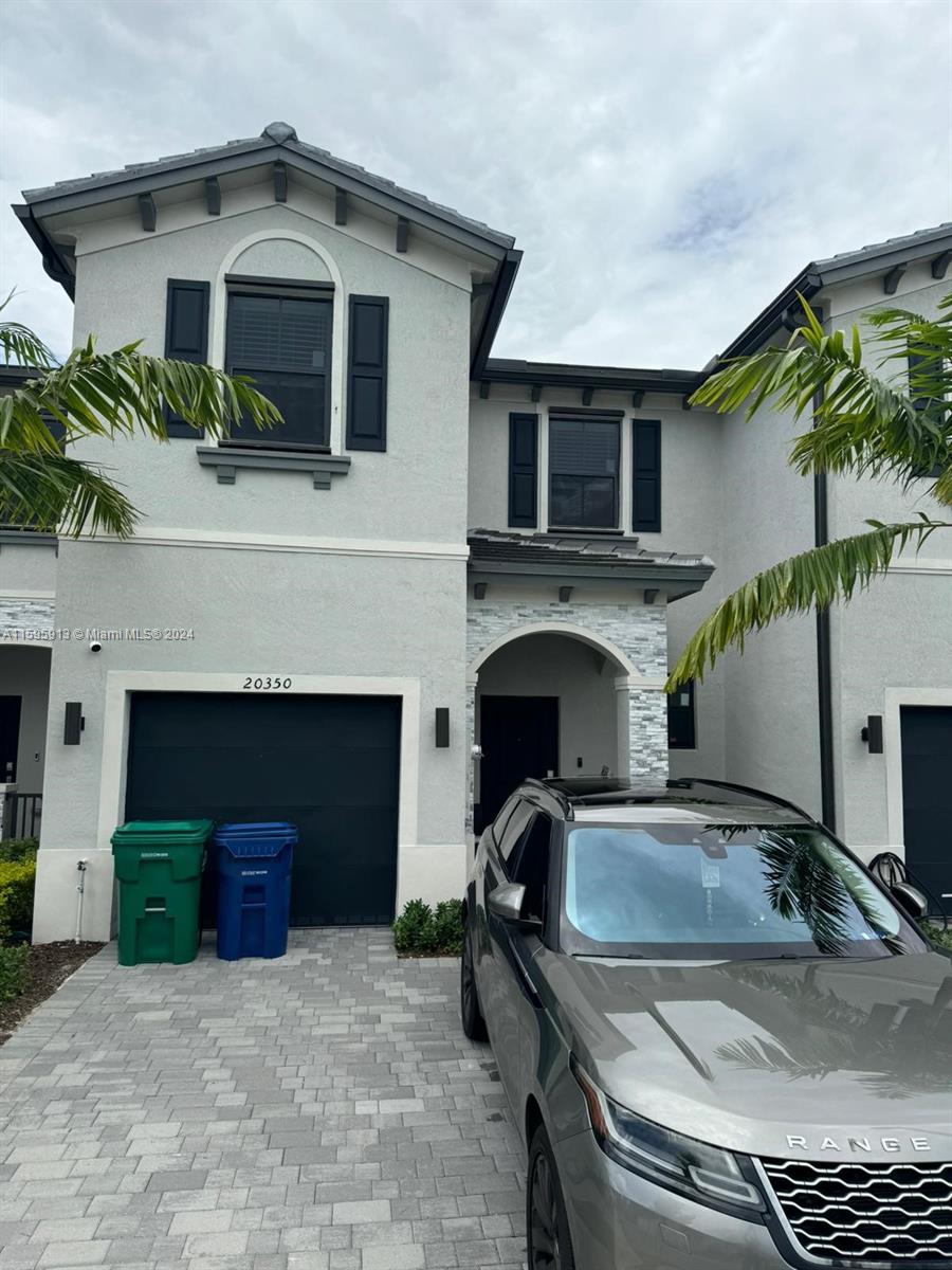 a front view of a house with parking space