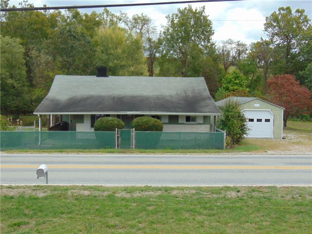 a view of green field with house in background