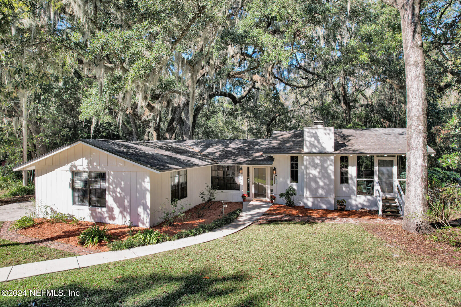 a front view of house with yard outdoor seating and barbeque oven