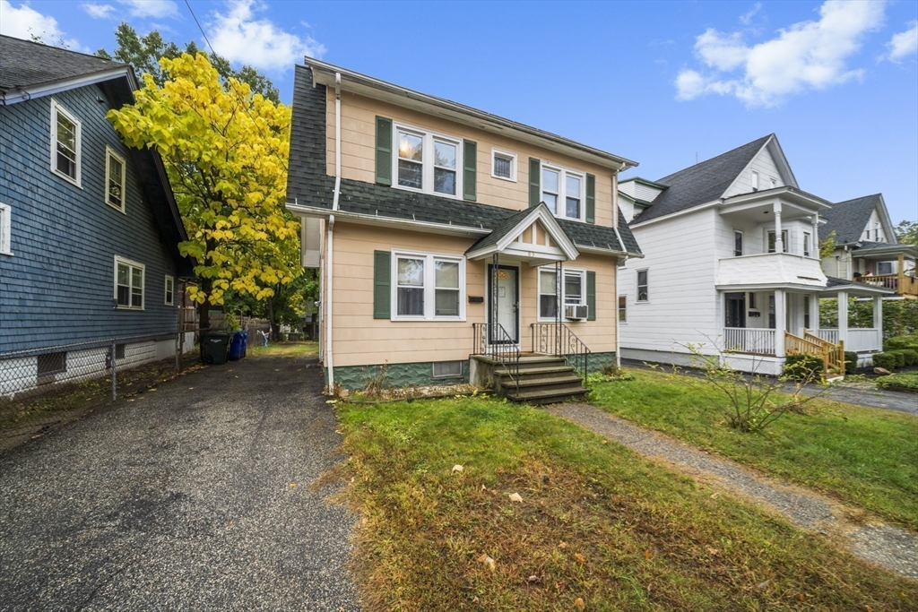 a view of a house with a yard