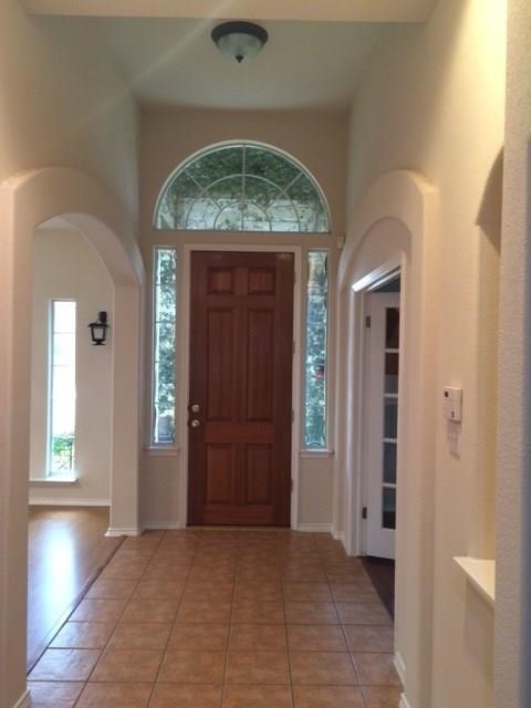 an empty room with closet and a hallway