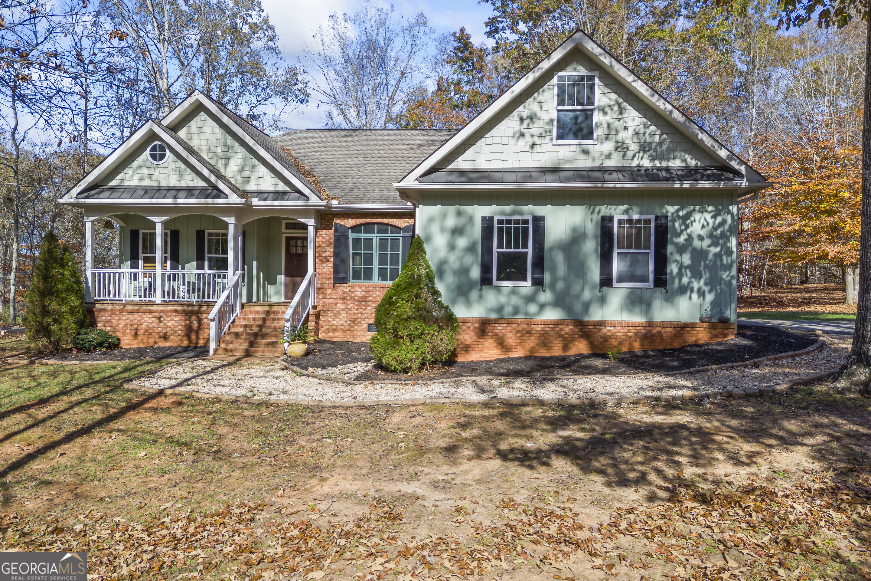 a front view of a house with a yard and porch