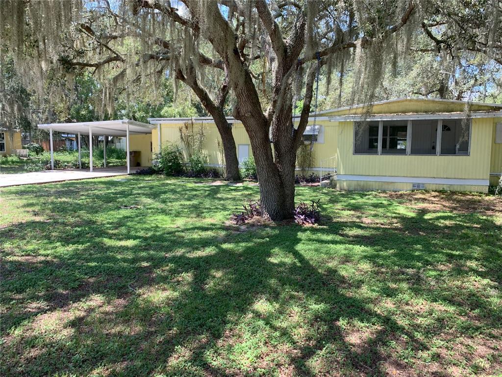 a view of house with backyard