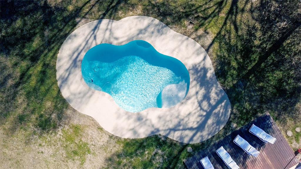 a view of a swimming pool in a backyard