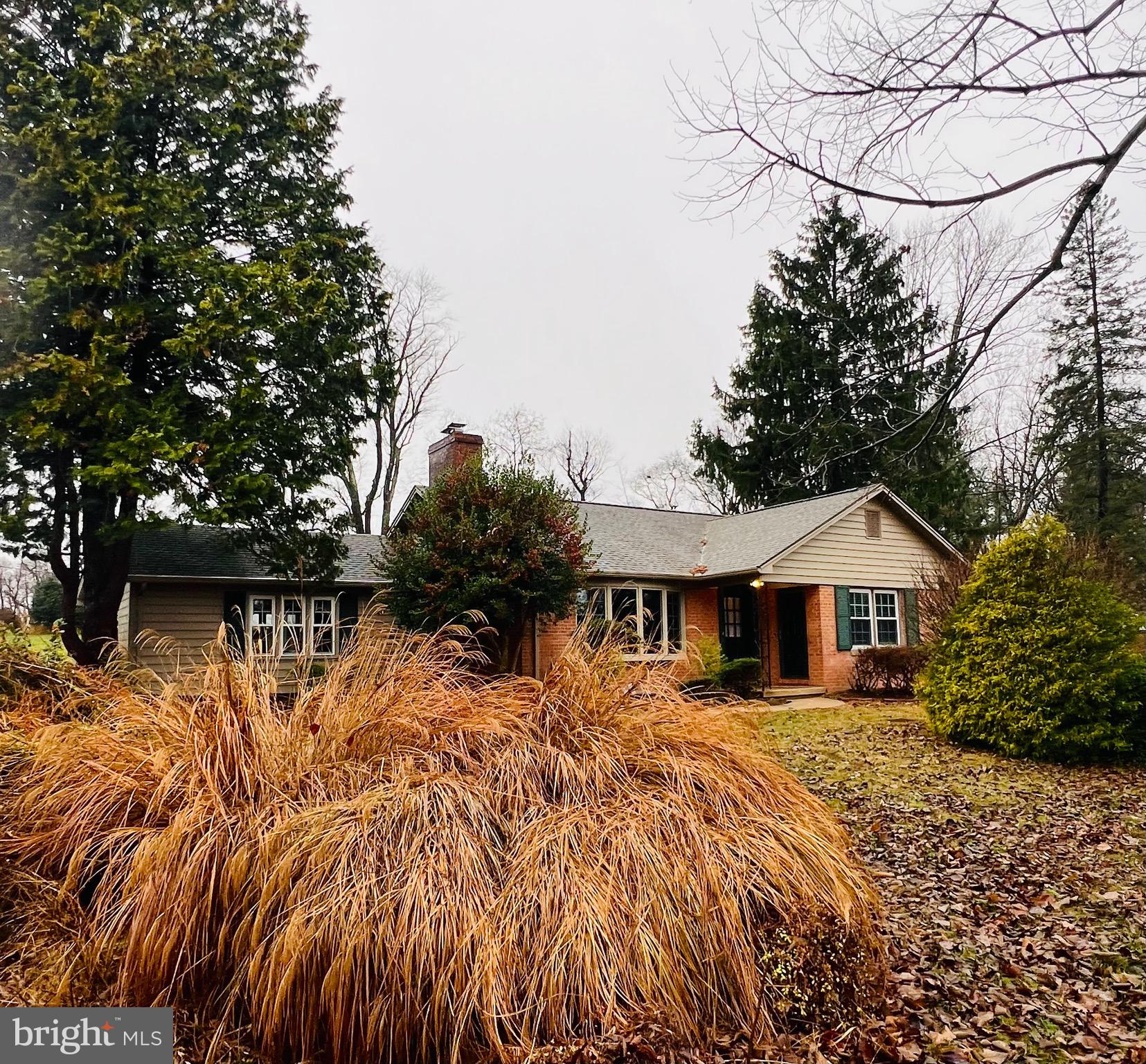 a view of house with yard and sitting area