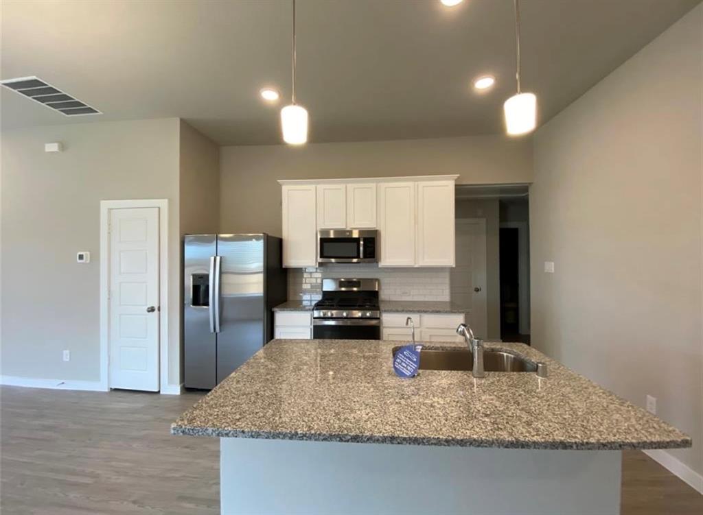 a kitchen with a refrigerator and a sink