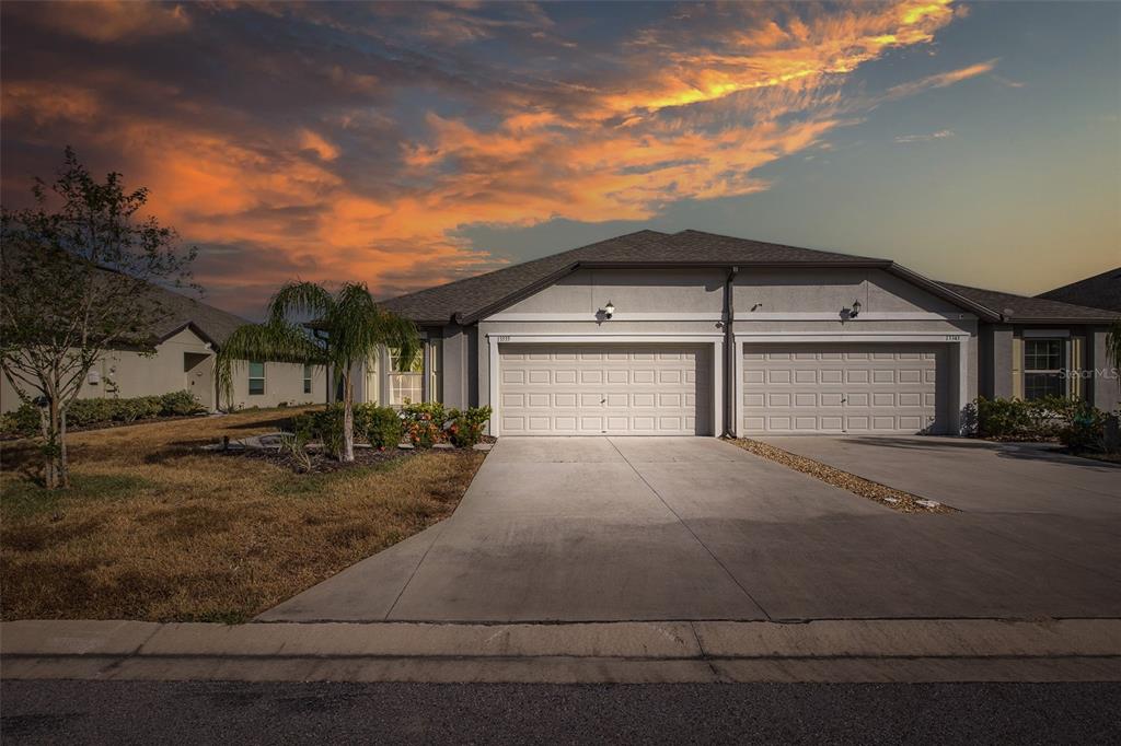 a front view of a house with a yard and garage