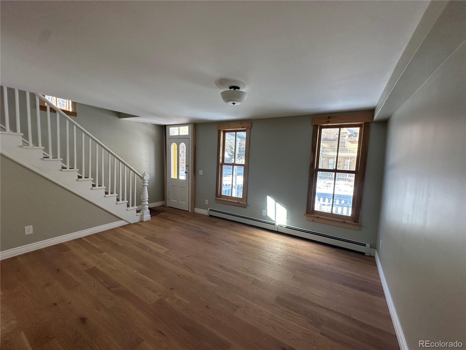 a view of an entryway with wooden floor