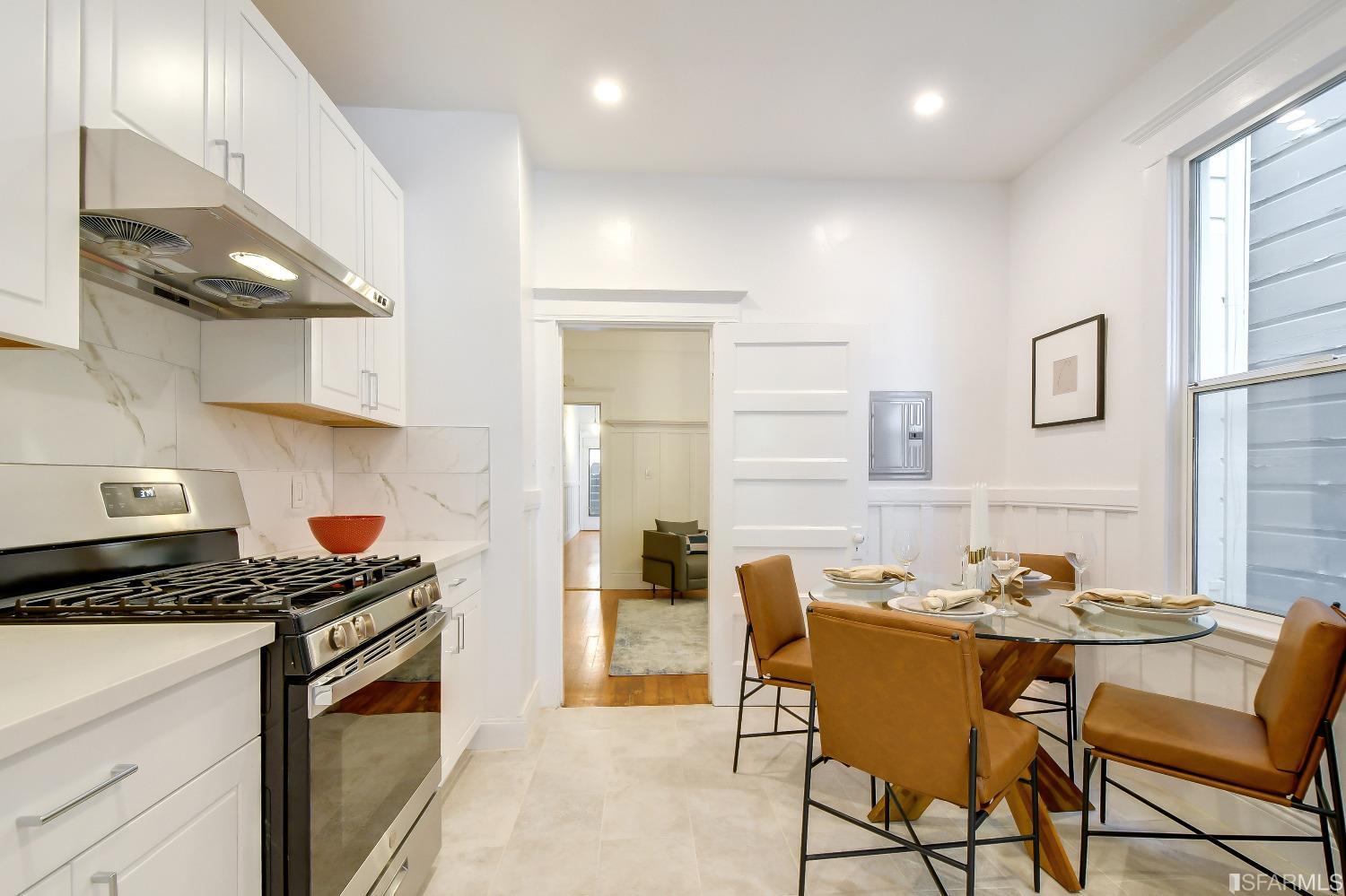 a kitchen with a dining table and chairs