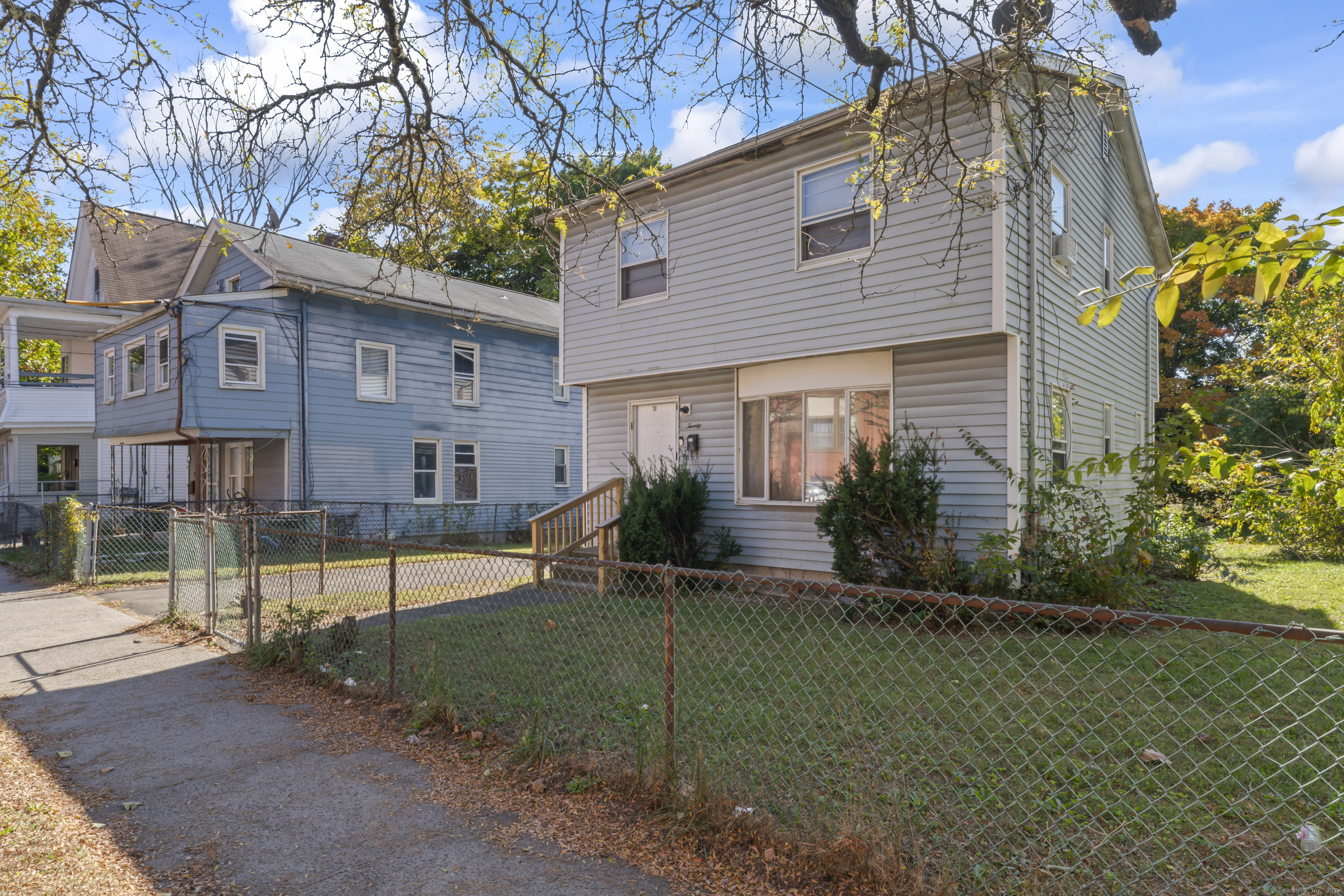 a view of a house with a yard and tree