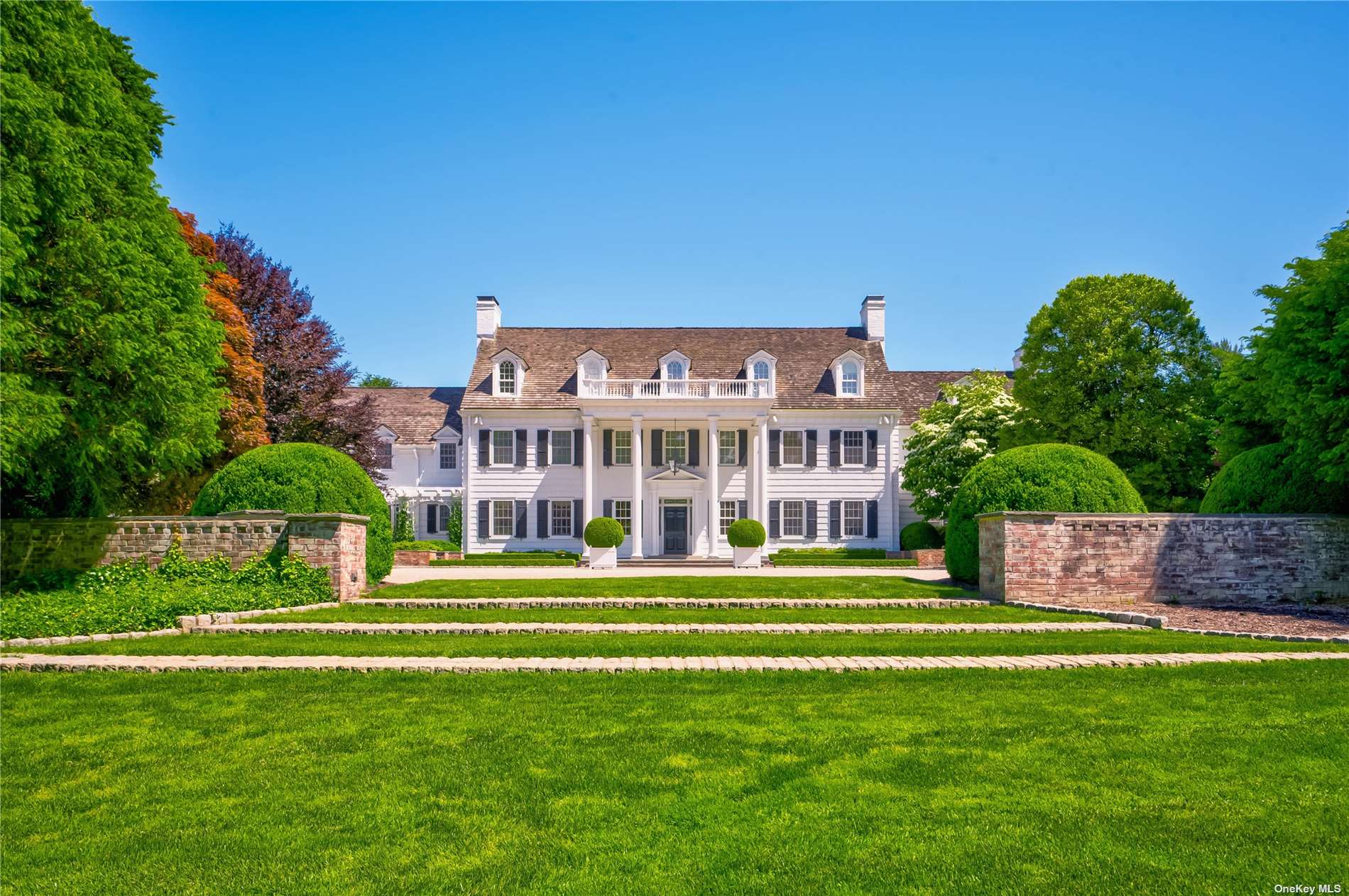 a view of a big building with a big yard and large trees