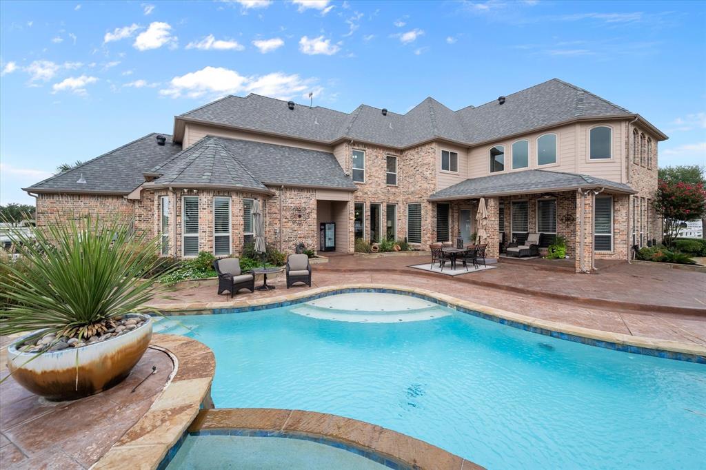 a view of a white house with a swimming pool and a yard