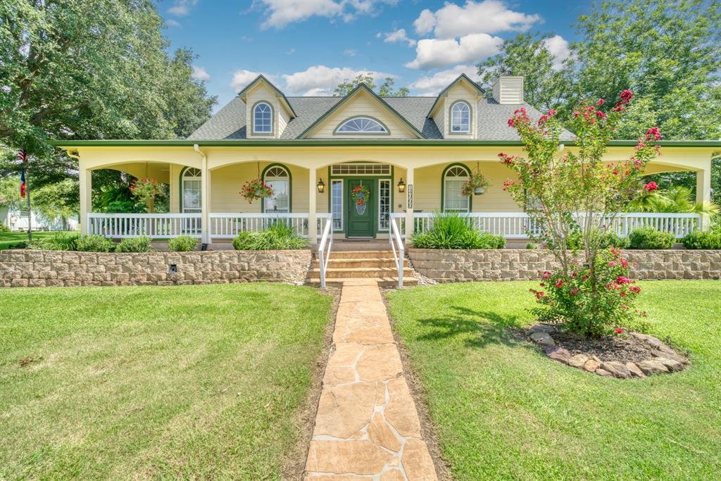 a front view of a house with a garden and plants