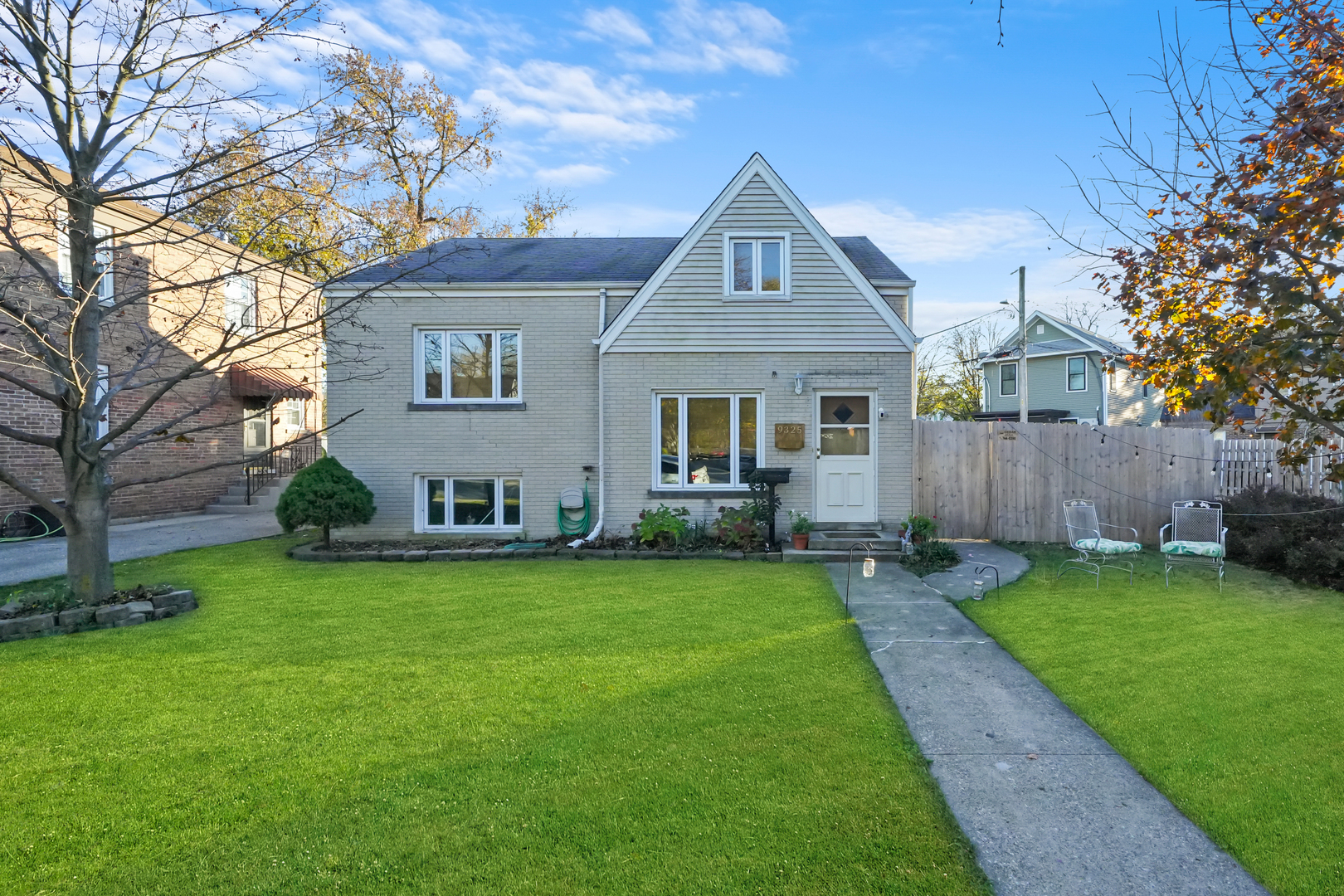 a front view of a house with a garden