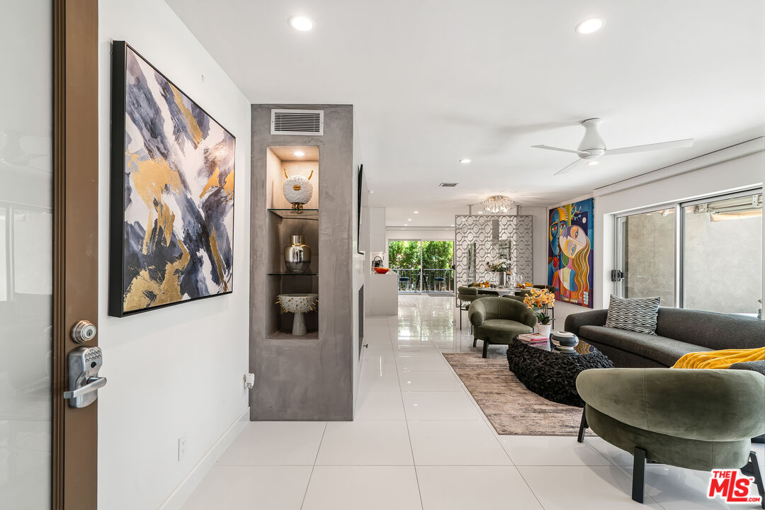 a living room with furniture and painting on the wall