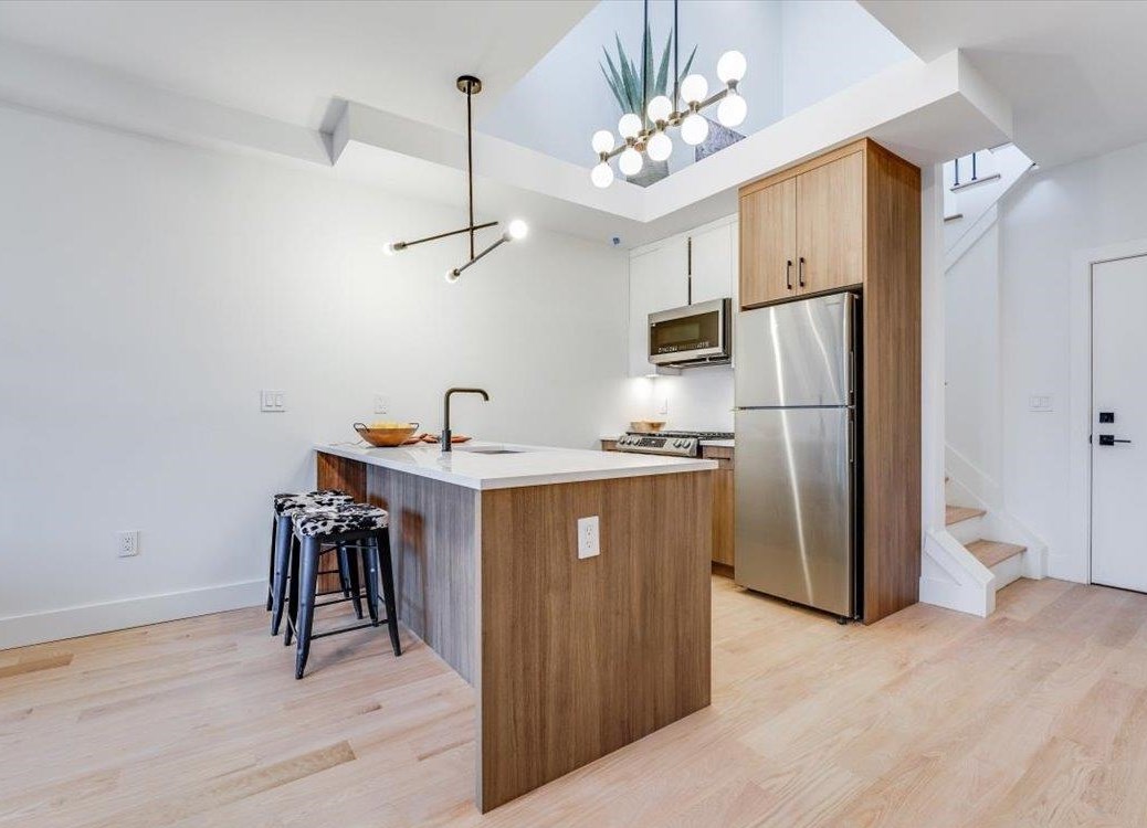 a kitchen with refrigerator cabinets and wooden floor