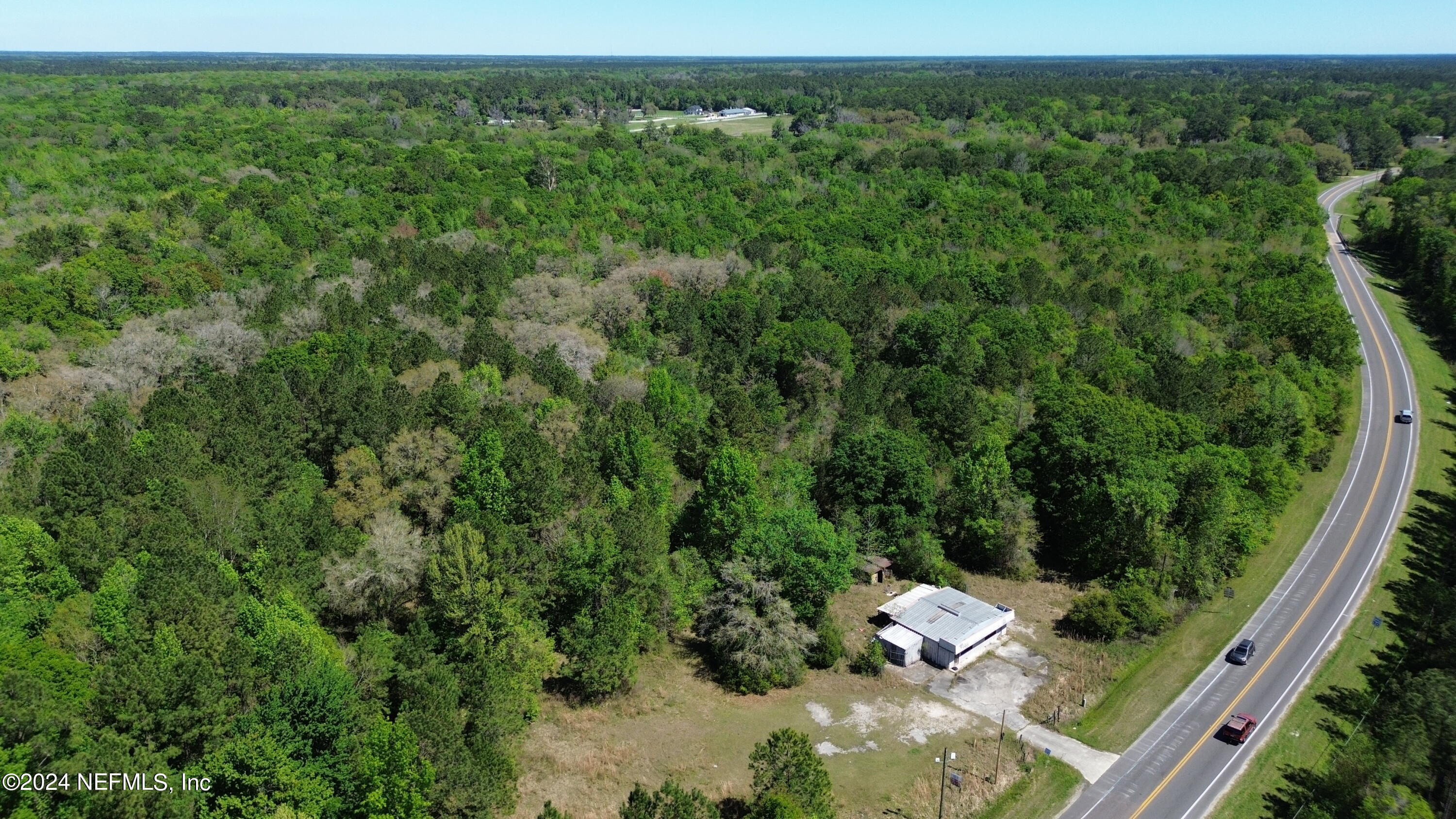 an aerial view of a house with yard