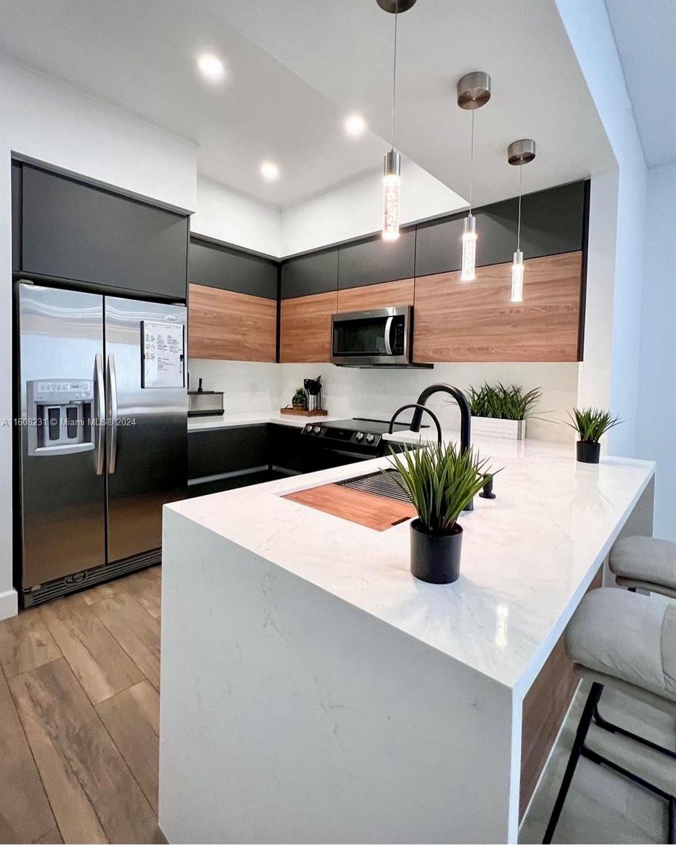 a kitchen with stainless steel appliances a sink counter space and cabinets