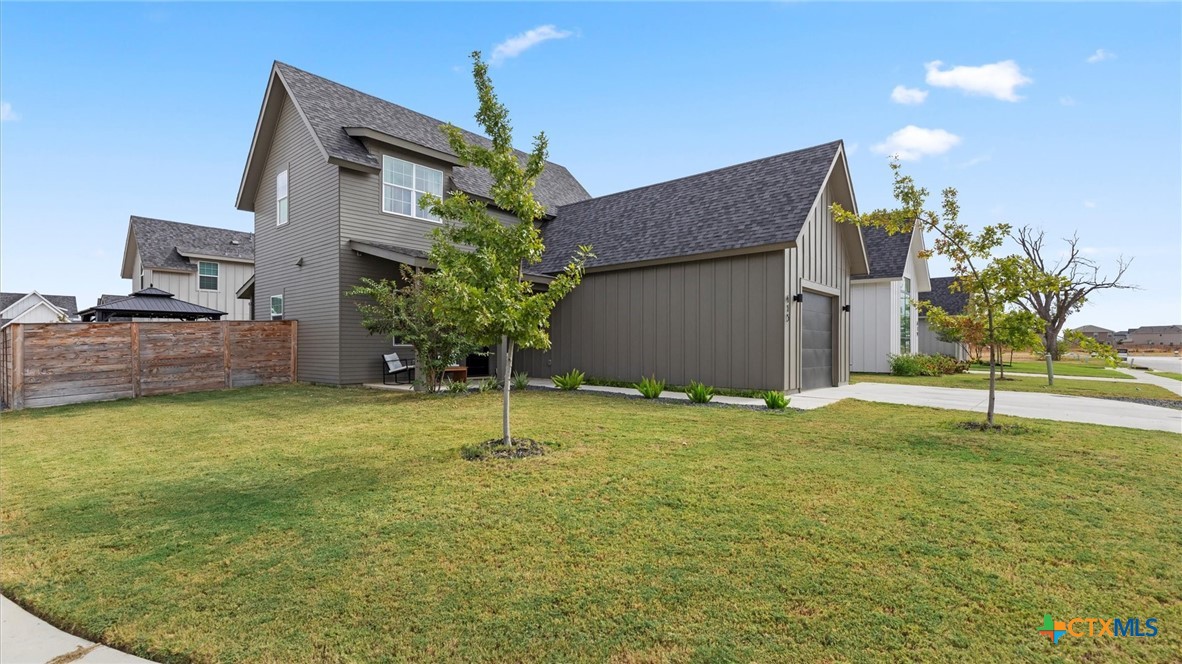 a house with a yard and a large tree