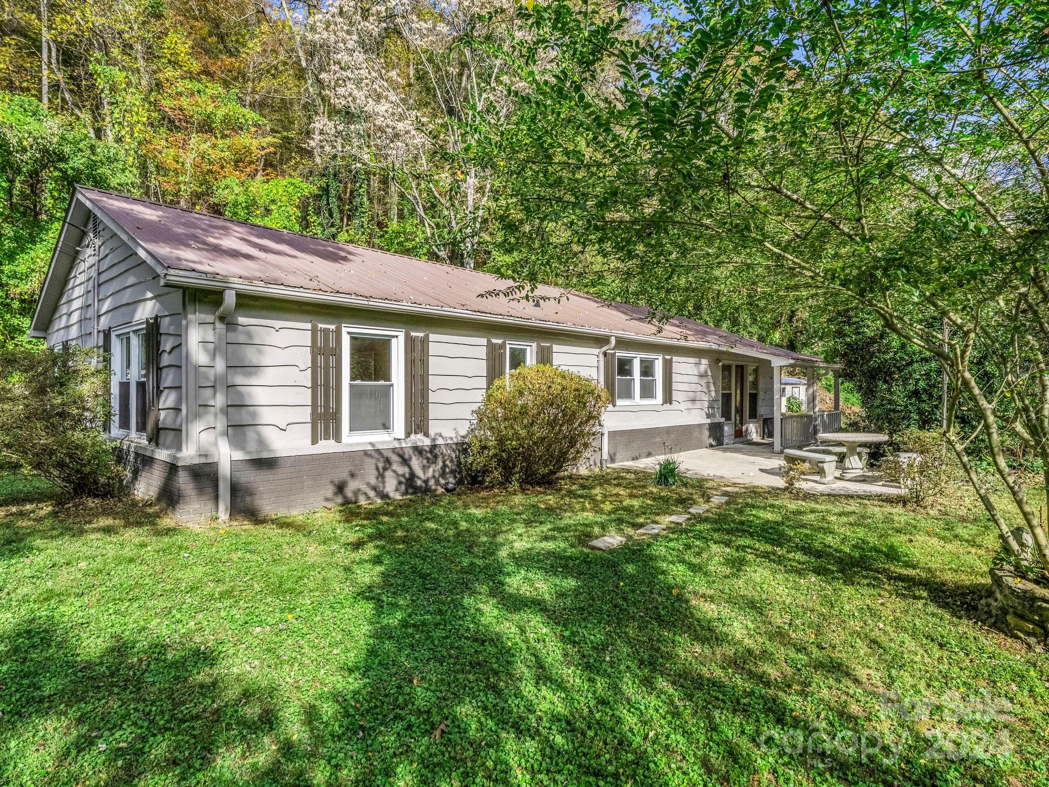 a front view of house with yard and green space