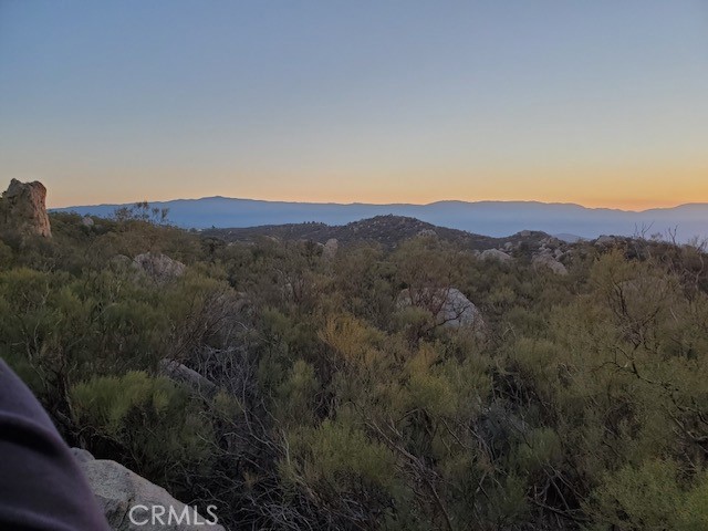 a view of a mountain range with trees in the background