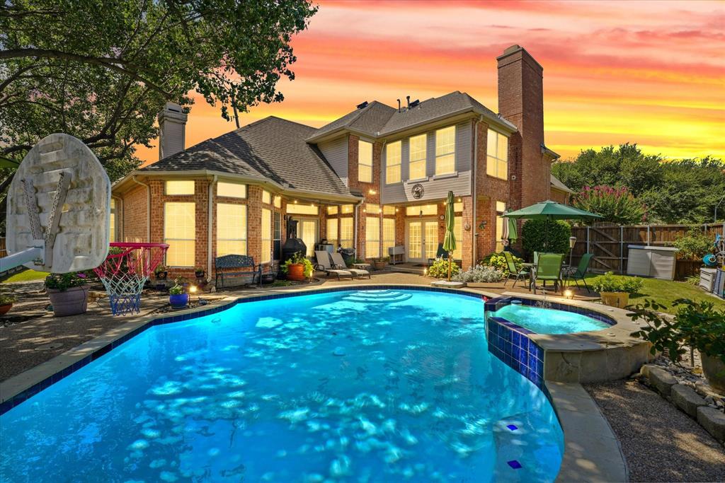 a view of a house with swimming pool and sitting area