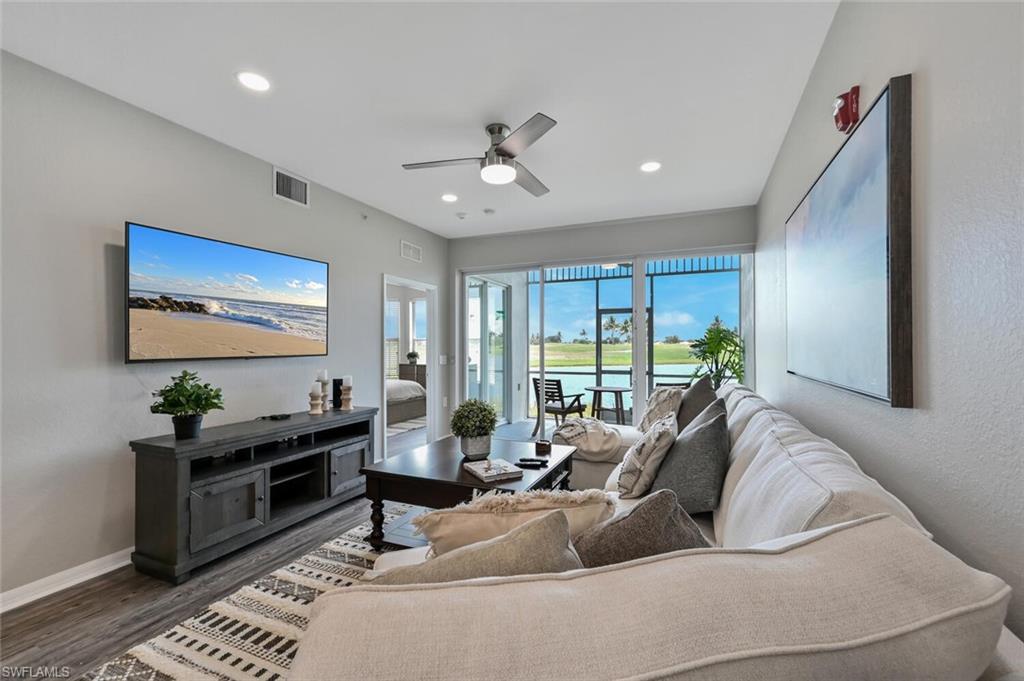 Living room featuring ceiling fan and dark hardwood / wood-style floors