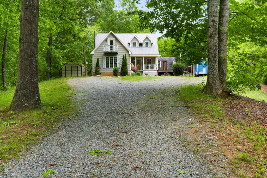 a front view of a house with a yard and trees