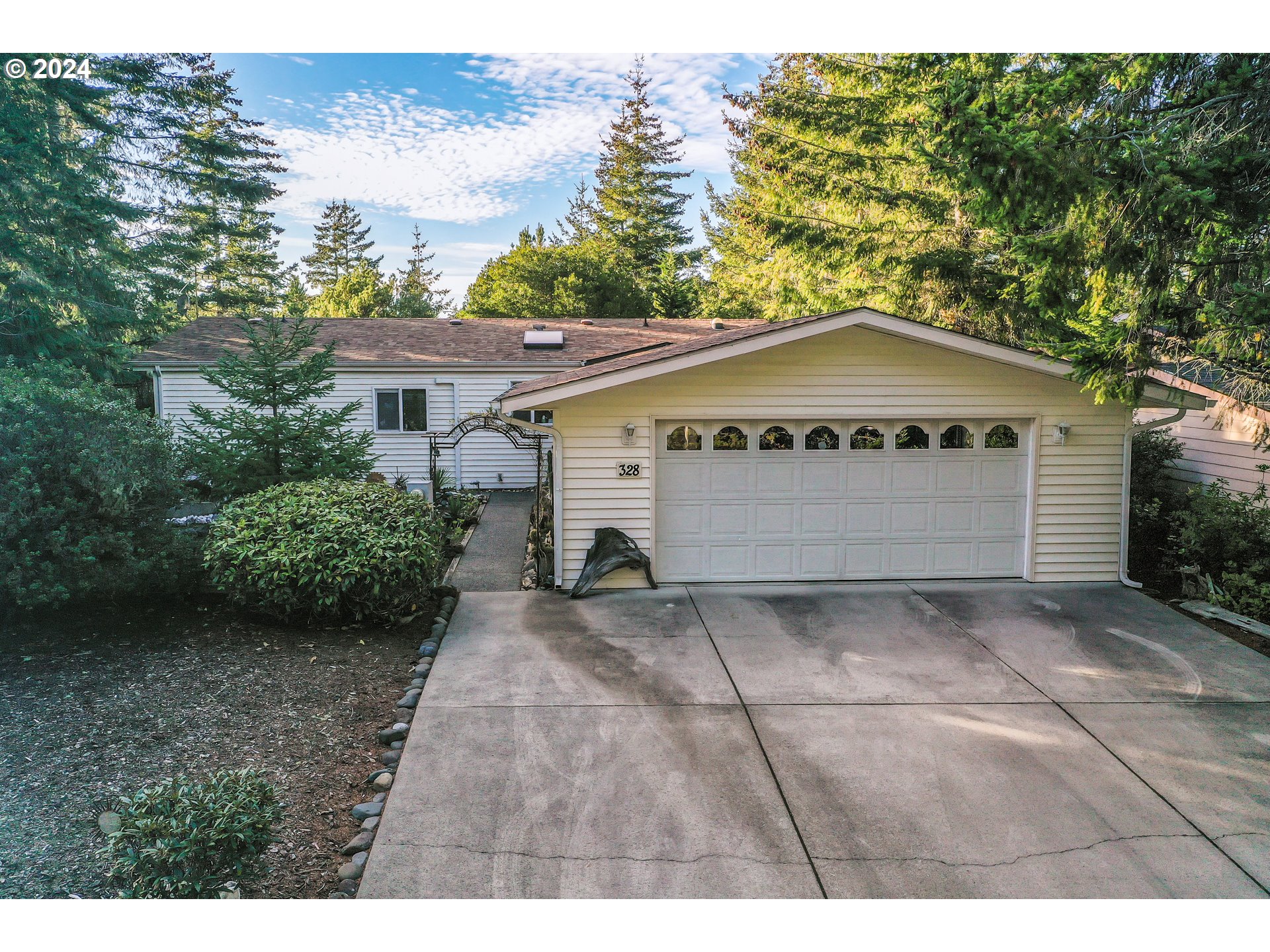 a view of a grey house with a yard