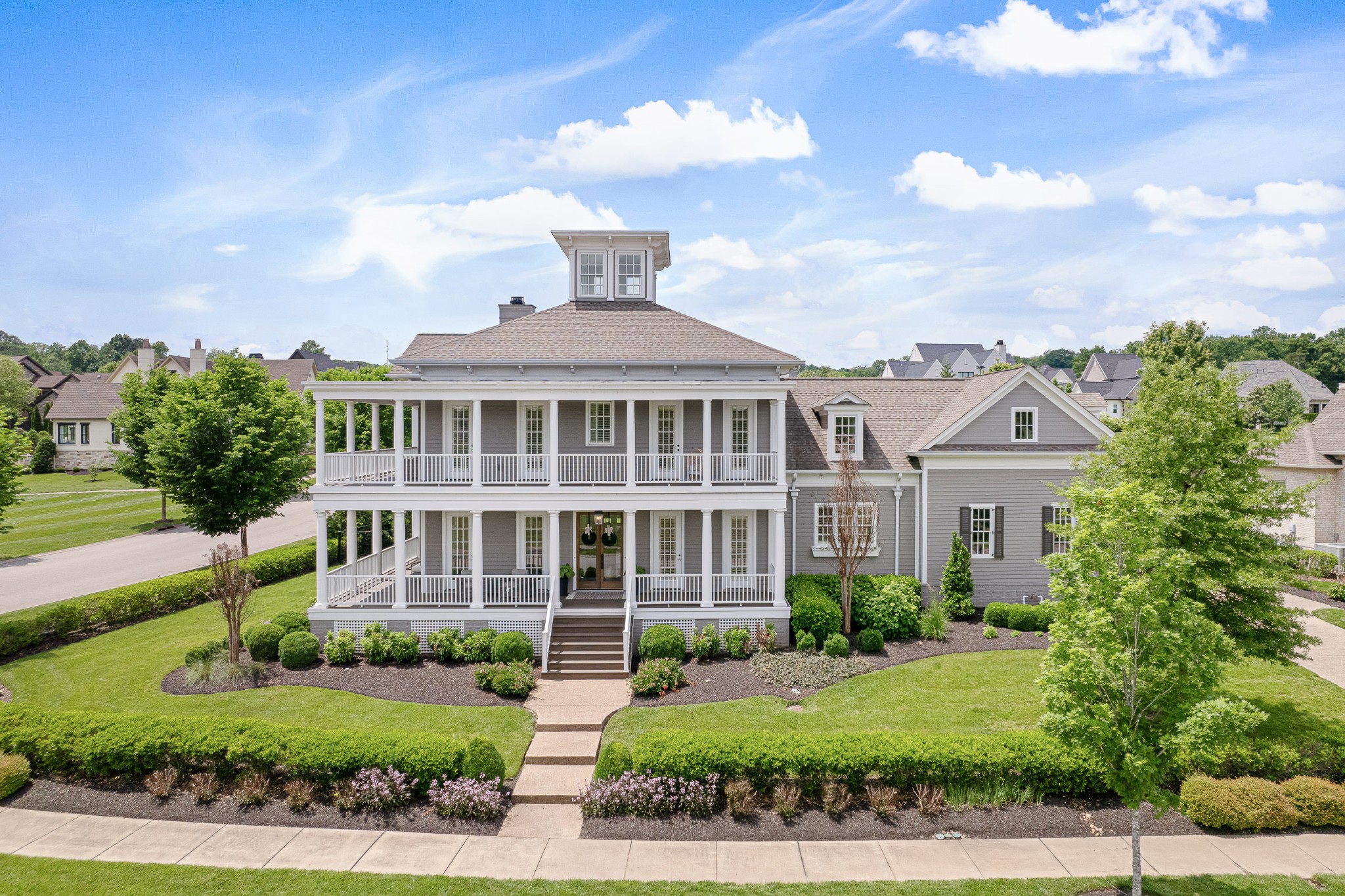 a front view of a house with a garden