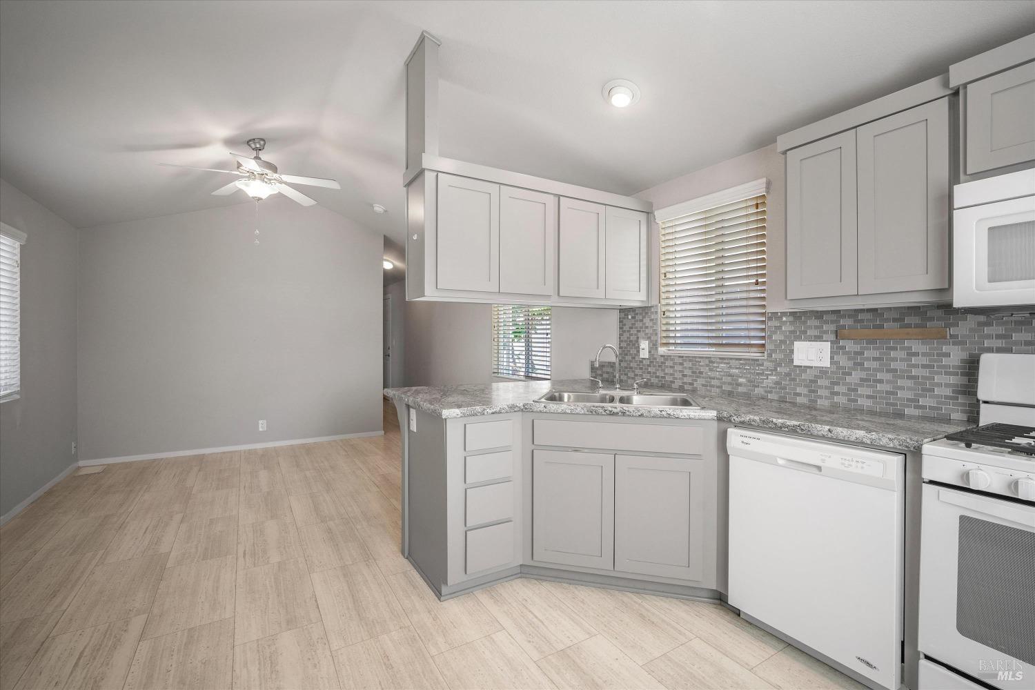 a kitchen with a sink cabinets and window