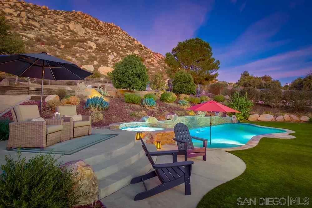 swimming pool view with a seating space