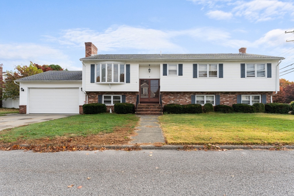 a front view of a house with a yard swimming pool and a yard