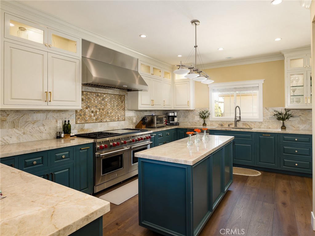 a kitchen with a sink stove and cabinets