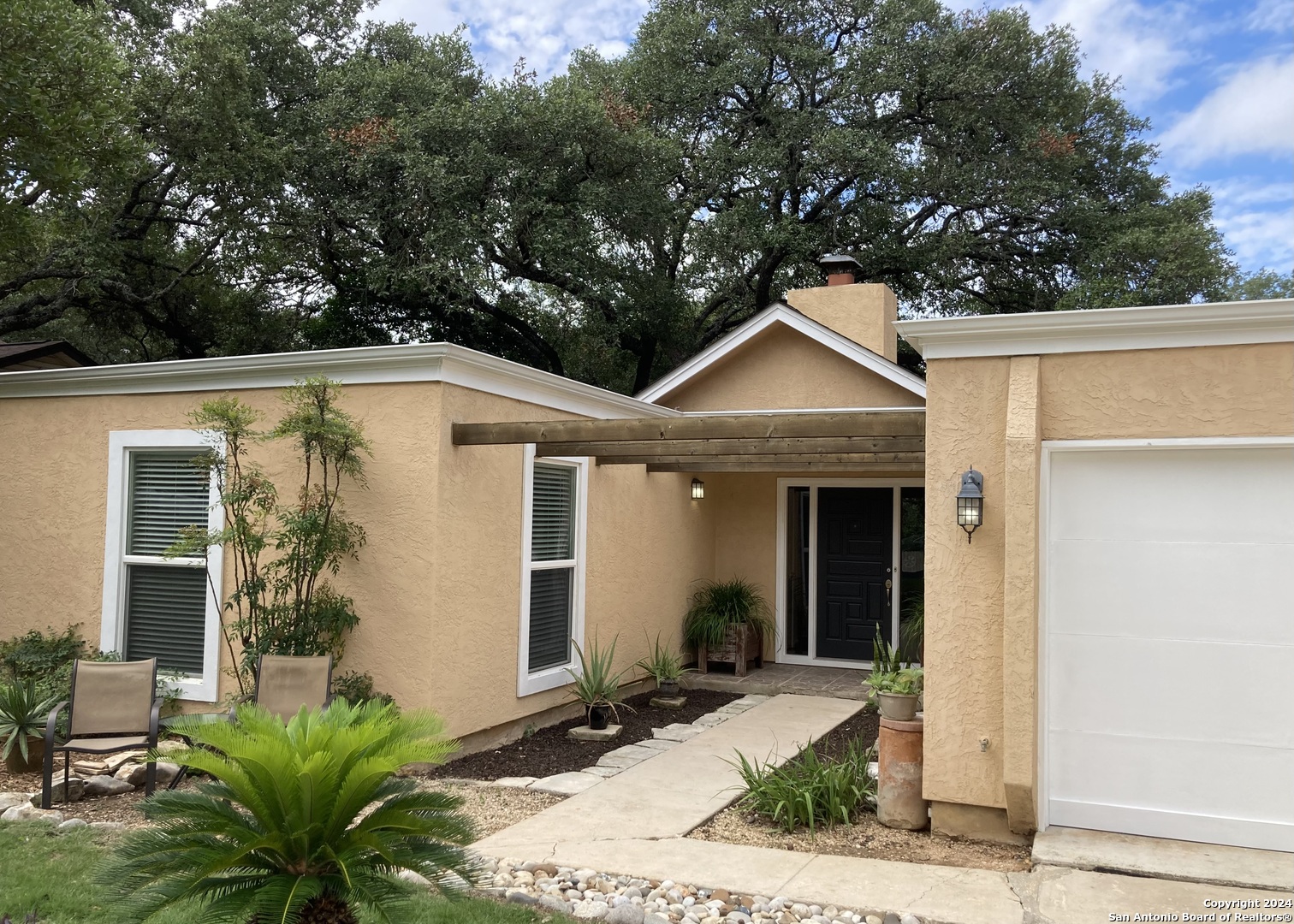 a front view of a house with garden