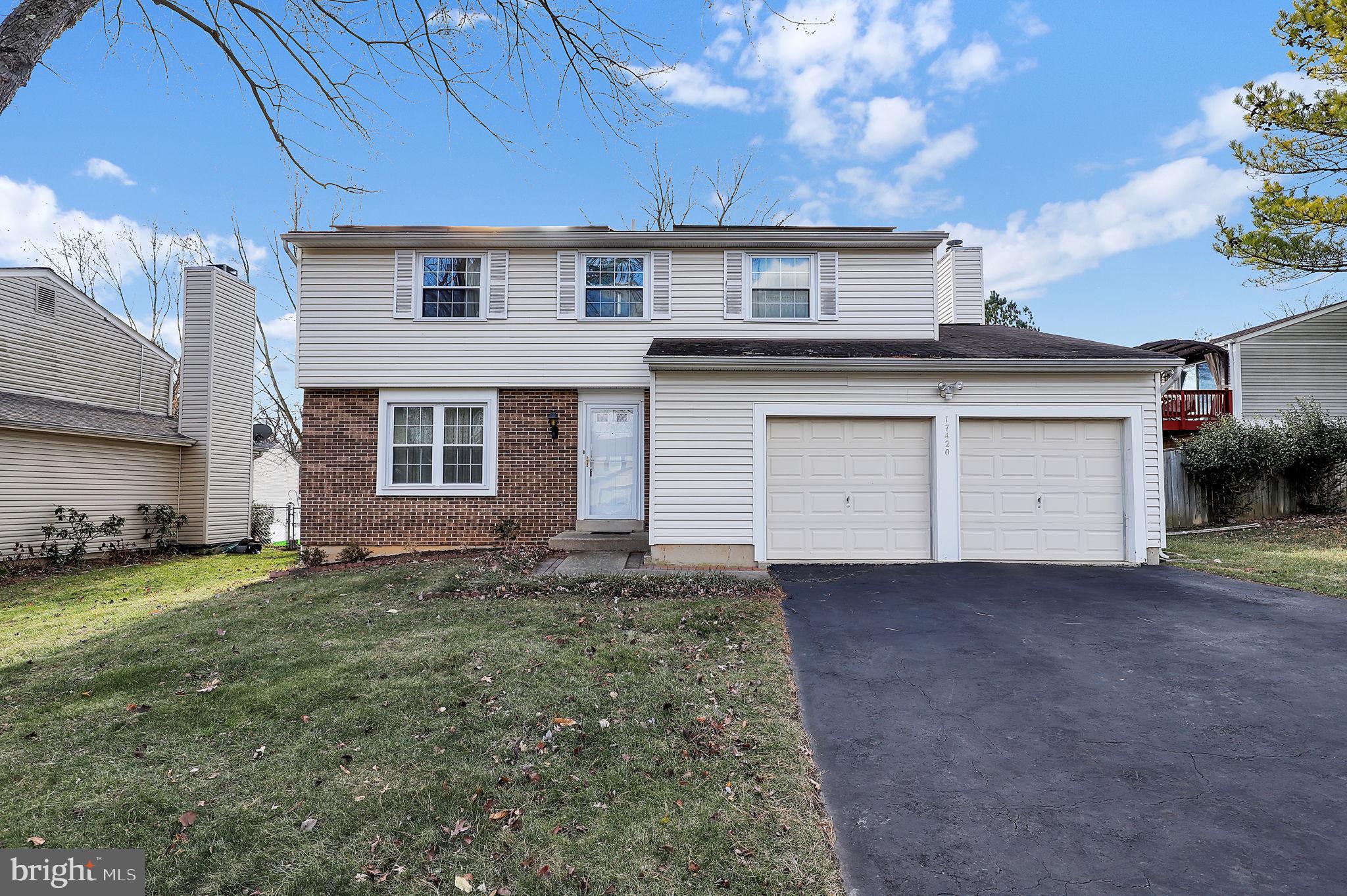 a view of a house with a yard and garage