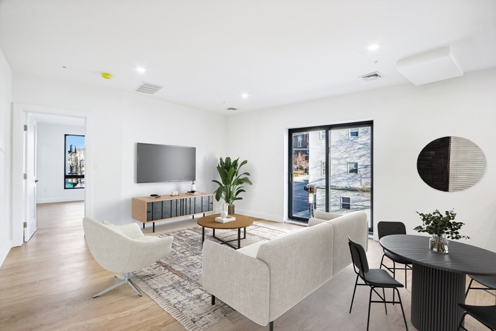 a living room with furniture potted plant and a large mirror