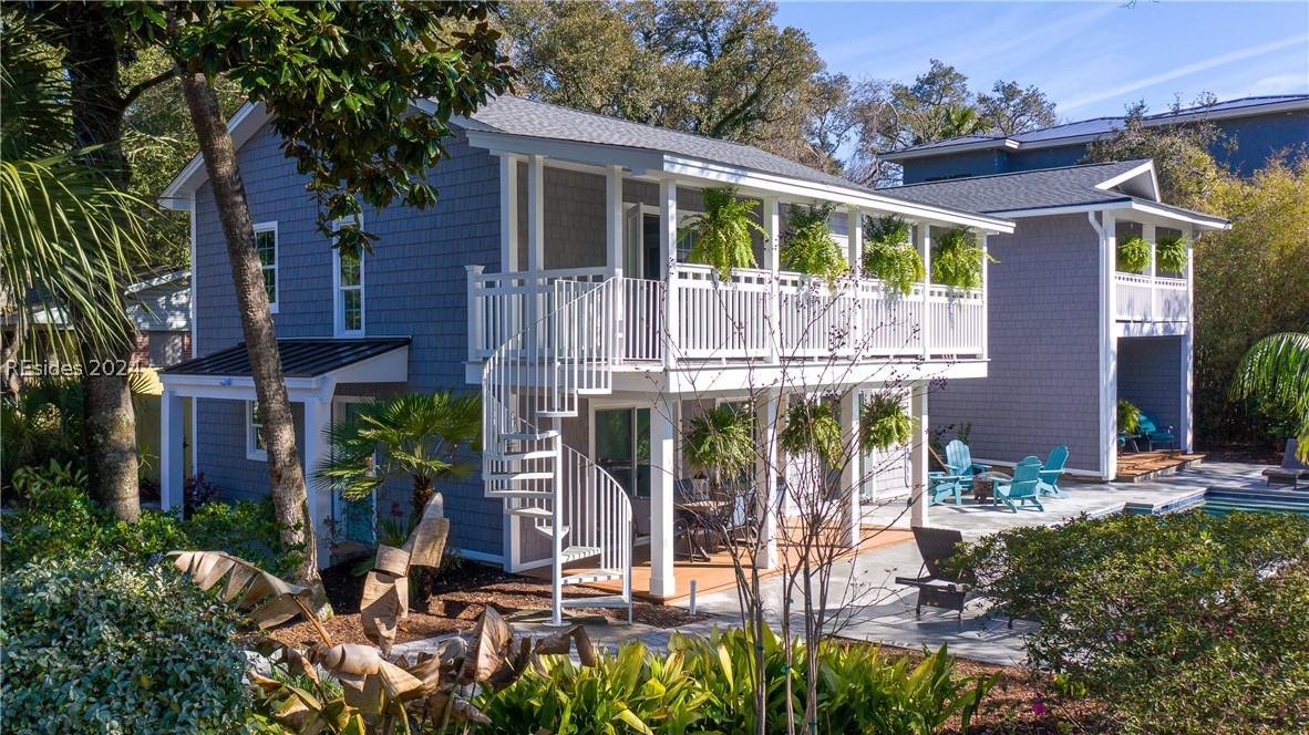 Rear view of property featuring a balcony and a pa