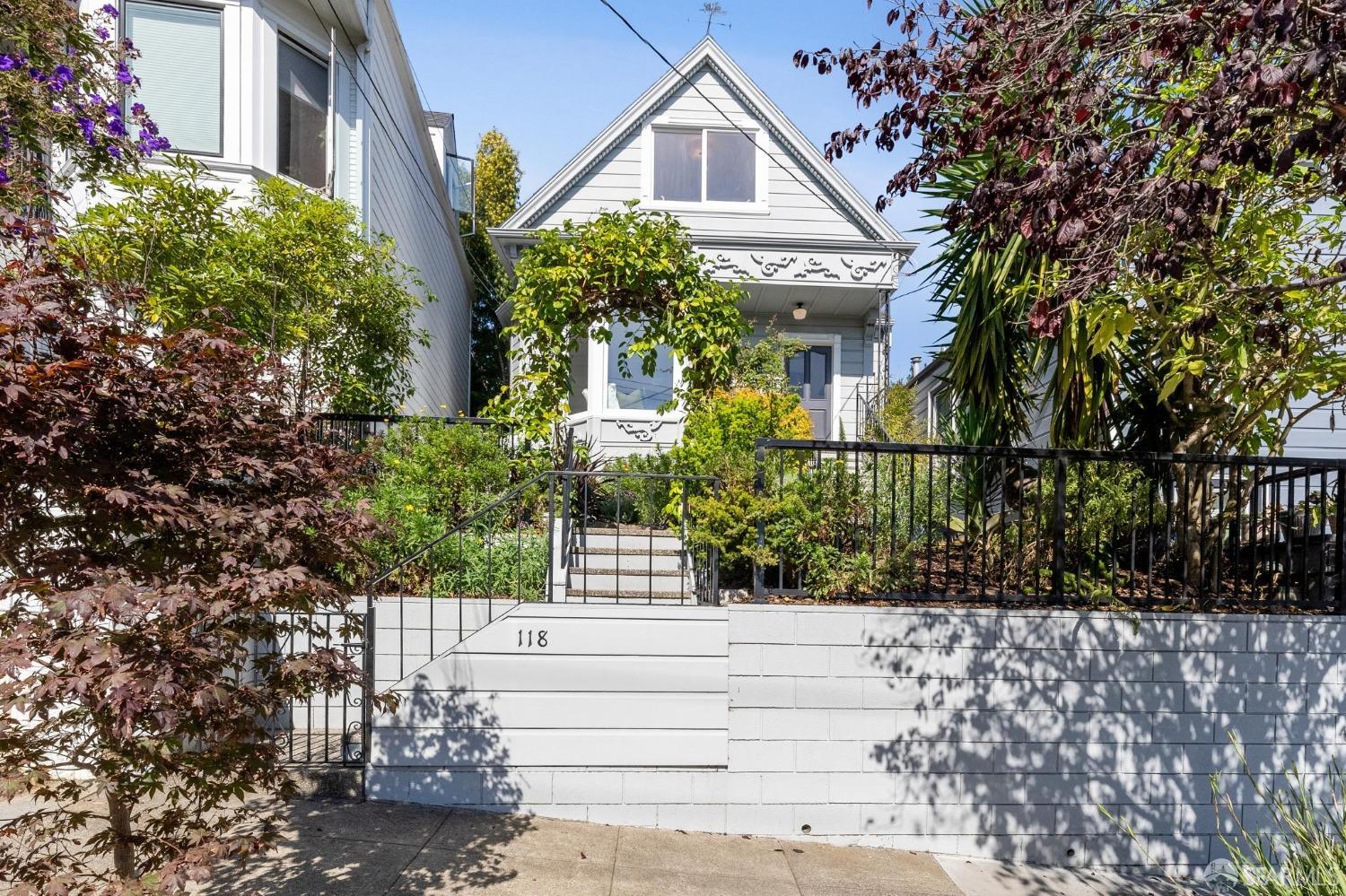 a front view of a house with a garden