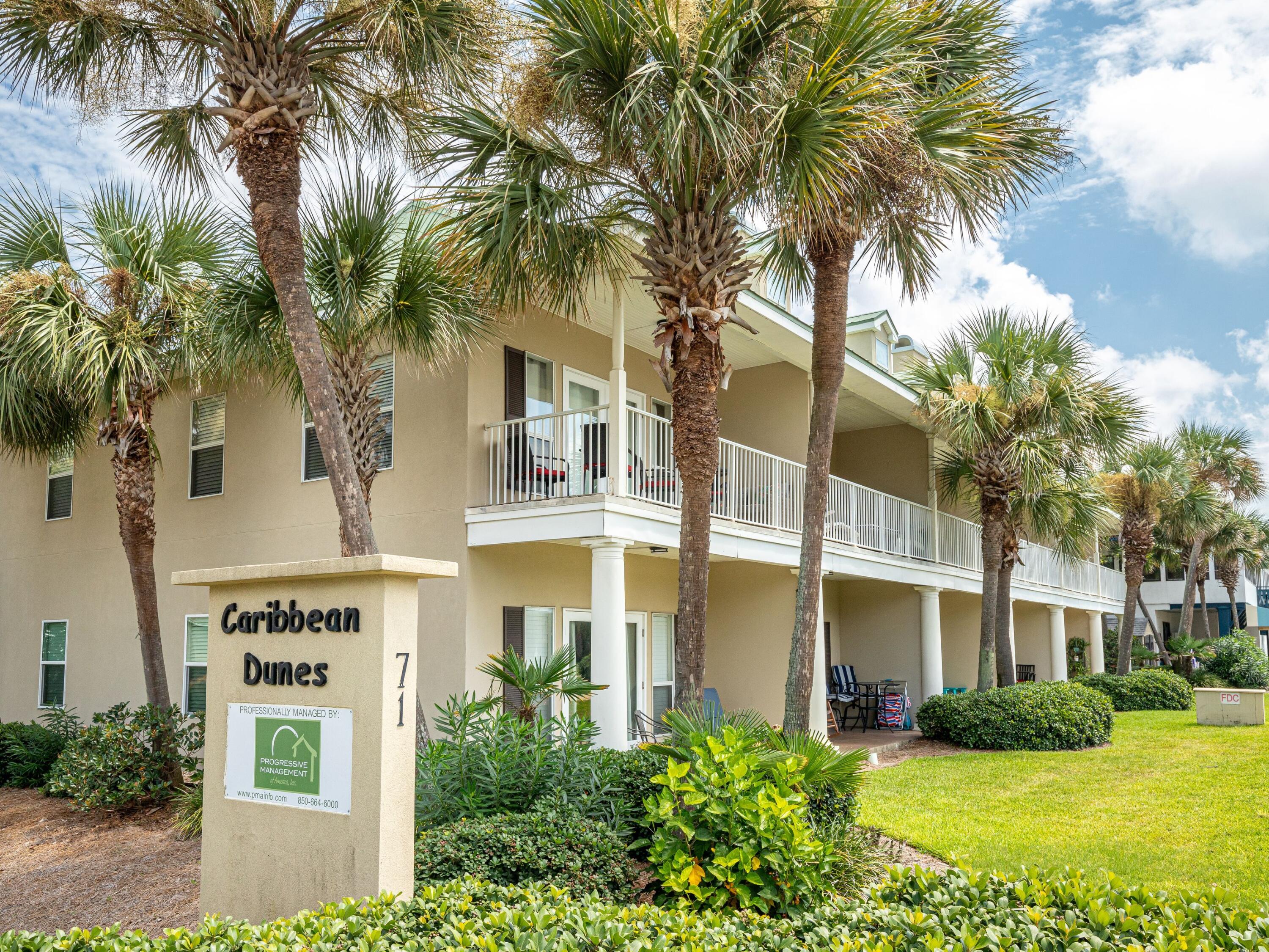 a front view of a residential apartment building with a yard