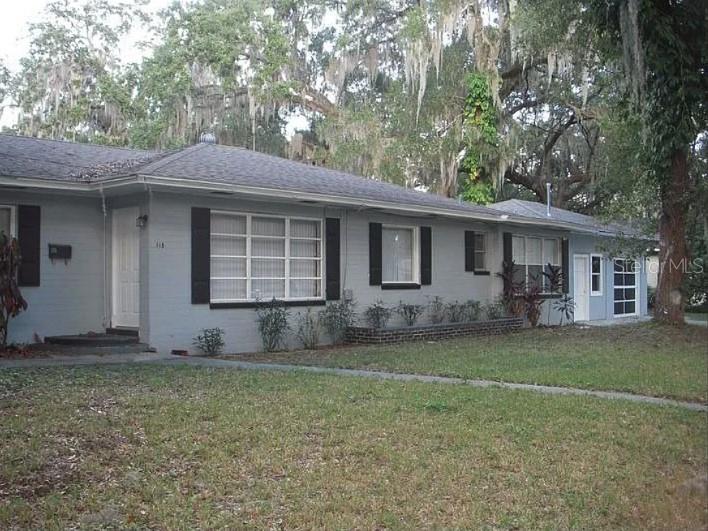 a front view of a house with a garden