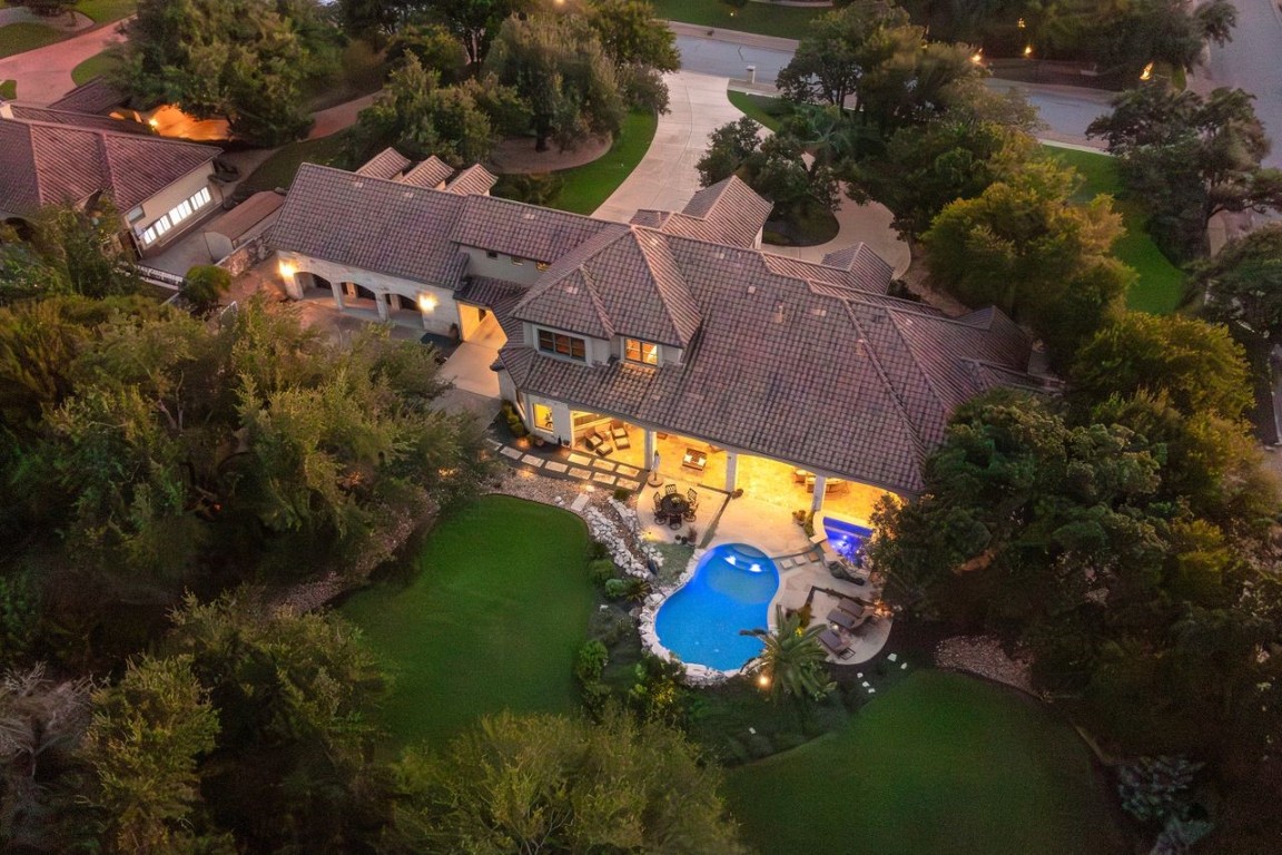 an aerial view of a house with a yard basket ball court and outdoor seating