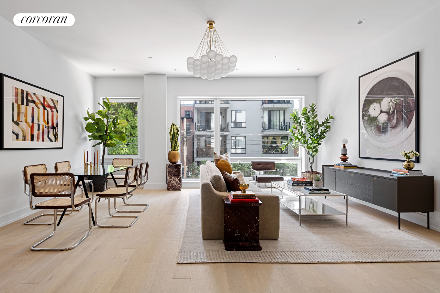 a living room with furniture and a chandelier