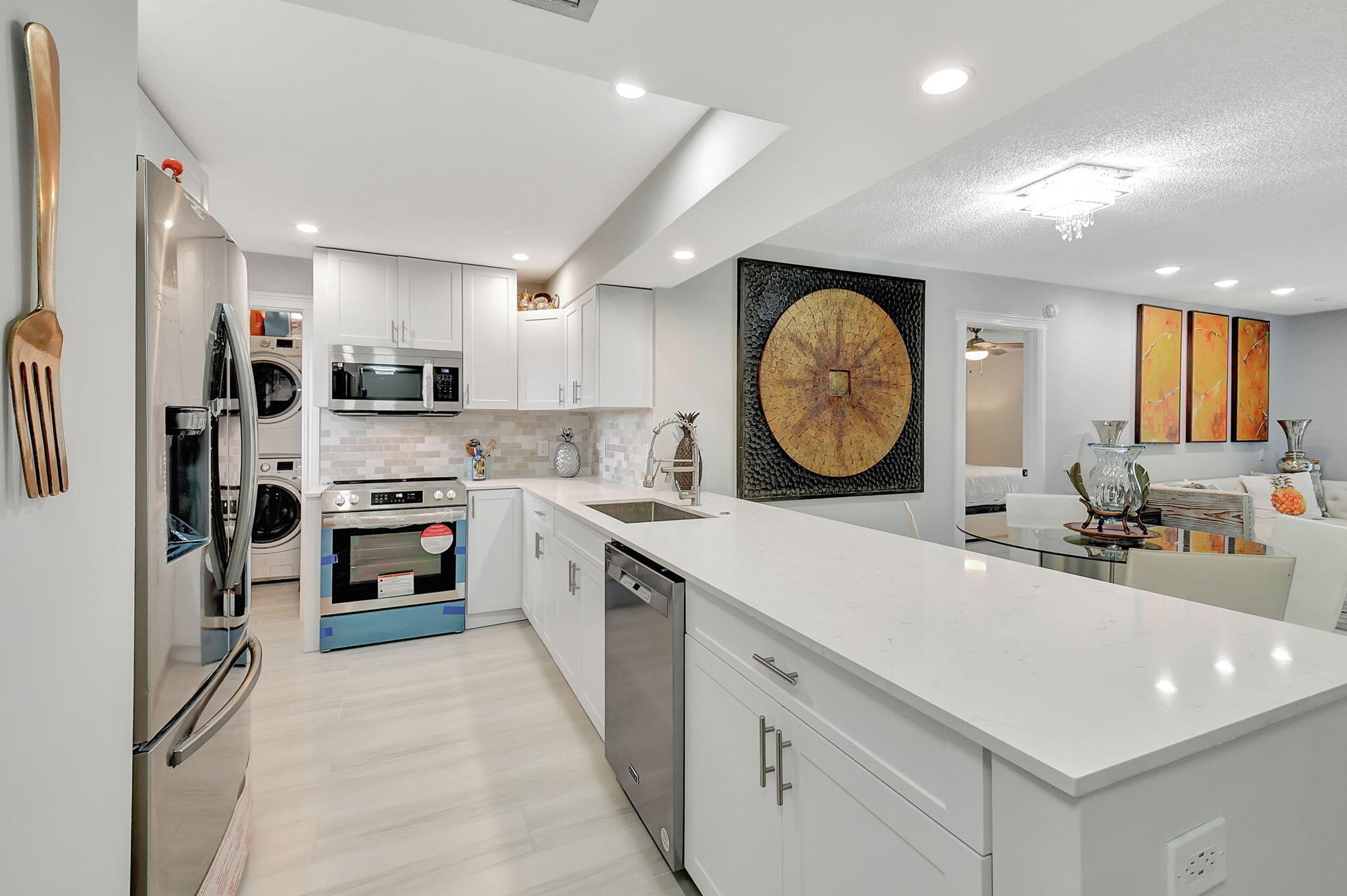 a kitchen with a sink a stove a refrigerator and a refrigerator