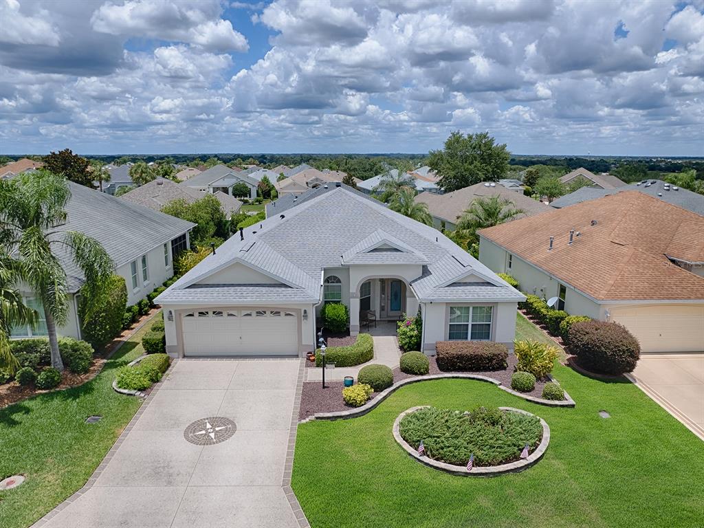 an aerial view of a house with swimming pool and garden