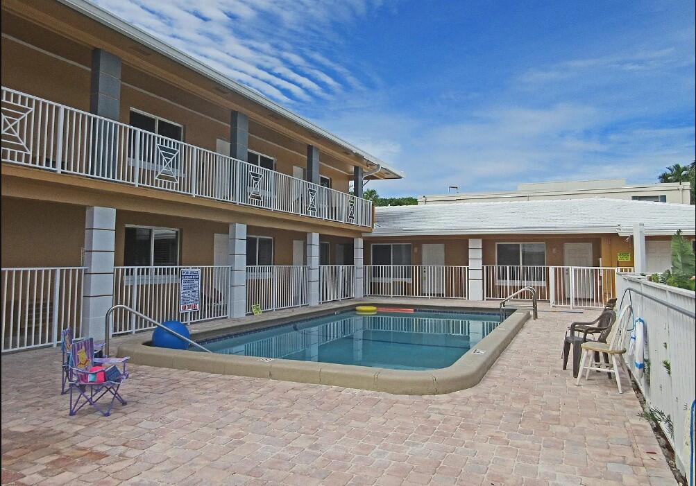 a front view of a house with swimming pool and porch