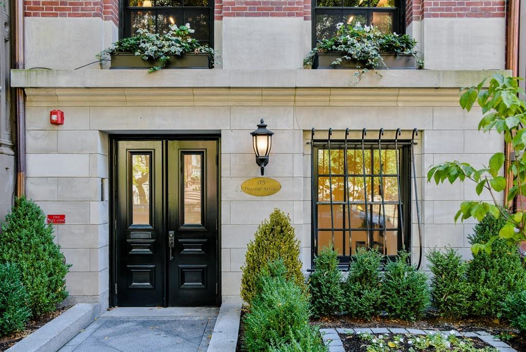 an entrance to house with potted plants