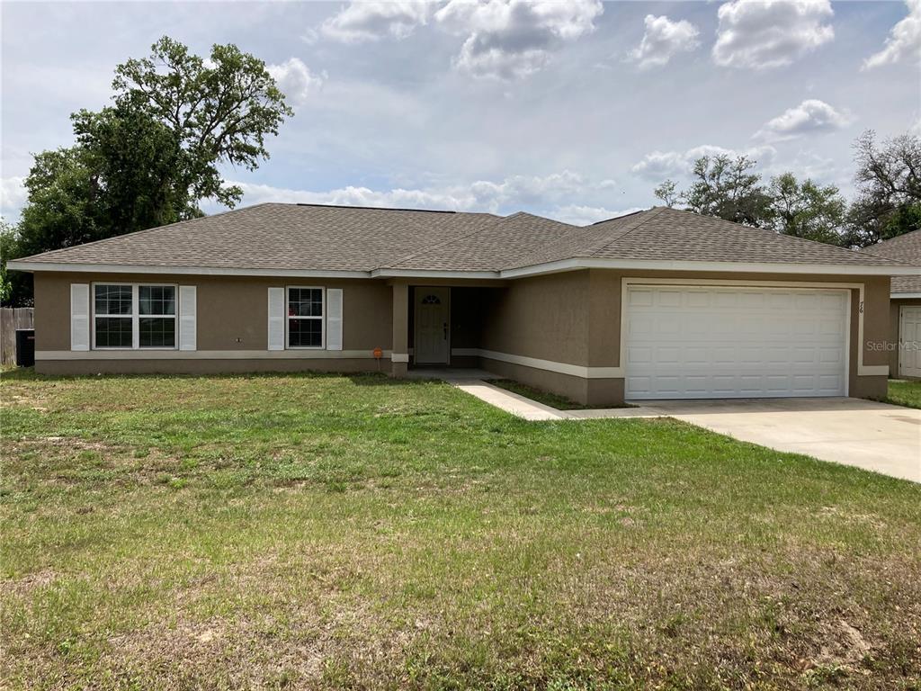 a front view of a house with a yard